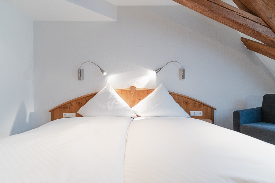 Rustikales Hotelzimmer mit offenen Dachbalken im Hotel Gasthof Zum Rössle Altenstadt